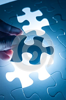 Hand insert jigsaw, conceptual image of business strategy