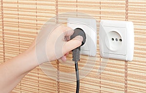 Hand insert the plug into the power