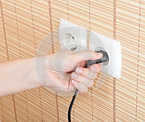 Hand insert the plug into the power