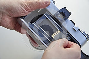 The hand that inserts the USB flash drive into the film camera