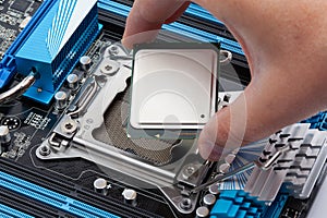 Hand Installing CPU Processor in Motherboard Socket for Computer Upgrade