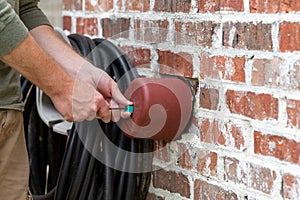 Hand installs faucet cover to protect it from freezing