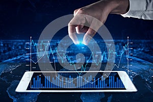 Hand Interacting with Digital Graph on Tablet Screen in Global Financial Market Concept with Data Visualization and
