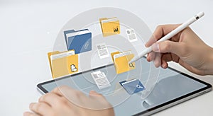 Hand interacts with tablet, managing digital documents and data