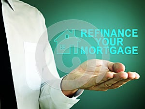 Hand with iscription refinance your mortgage photo