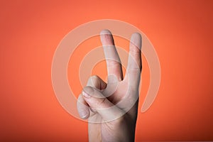 Hand isolated on orange red background