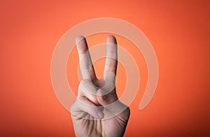 Hand isolated on orange red background