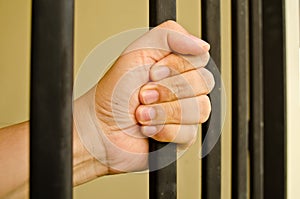 Hand on a jail bar