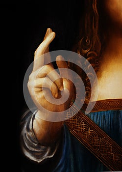 Hand of Jesus Christ in symbolic gesture. Detail from my own reproduction of Leonardo DaVinci painting Saviour of the photo