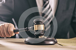 Hand of a judge holding a hammer or gavel