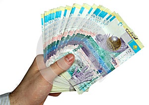 Hand with kazakh money