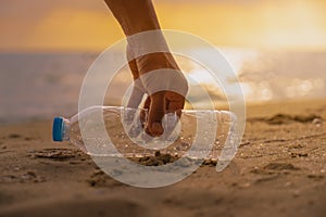 Hand Keep cleanup the Plastic bottle on beach at the sunset sc photo