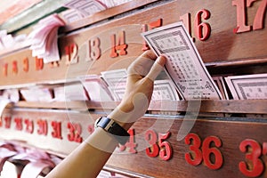 Hand keep fortune paper on shelf