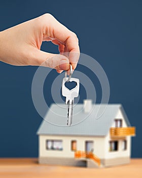 Hand, key and house