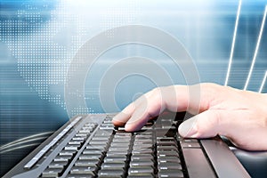 Hand on keyboard and technology background