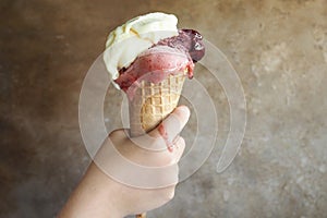 Kid holding the ice cream cone photo