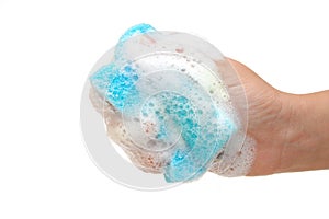 Hand and kitchen sponge in soapsuds