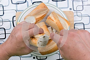 Hand with knife penetrate bread