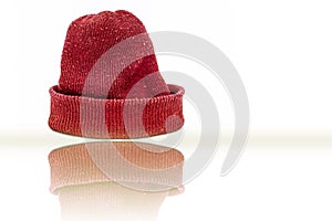 Hand knitted red-colored woolen cap isolated on white indicating Christmas