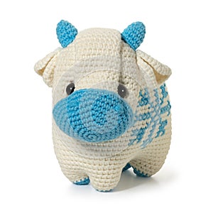 Hand knitted toy - white bull on white background. Full depth of field