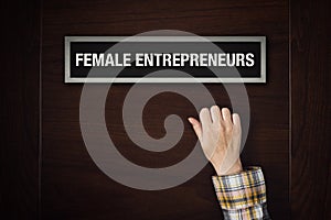 Hand is knocking on Female Entrepreneurs door photo
