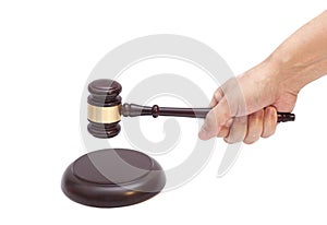 Hand knocking a Judge gavel at soundboard