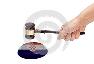 Hand knocking a Judge gavel at soundboard with Croatia Flag