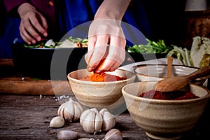 Hand of Korean woman, she making Kimchi which is a fermented food preservation of Korean people