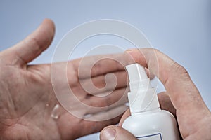 Hand of lady that applying alcohol spray or anti bacteria spray to prevent spread of germs, bacteria and virus. Personal