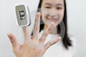 Hand of lady girl with an attached pulse oximeter on finger or fingertip  for examination of the lung disease,diagnose of