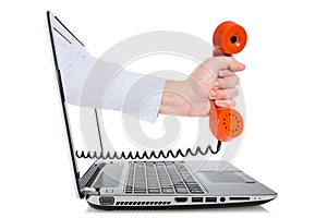 Hand through a laptop monitor giving a telephone receiver