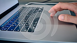 Hand on laptop touchpad