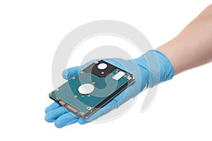 Hand in latex surgical glove hold hard disc, isolated on a white background. Hard drive in hand