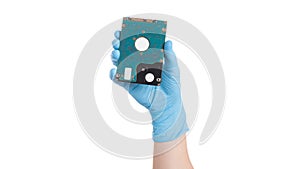 Hand in latex surgical glove hold hard disc, isolated on a white background. Hard drive in hand