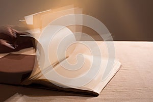 Hand leafing through the blank pages of the book