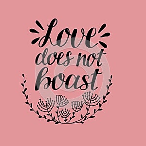Hand lettering with bible verse Love does not boast. made with flowers on pink background.