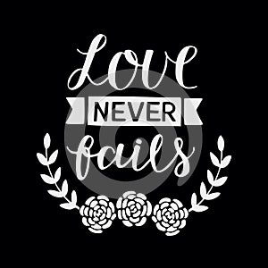Hand lettering with bible verse Love never fails made with flowers on black background