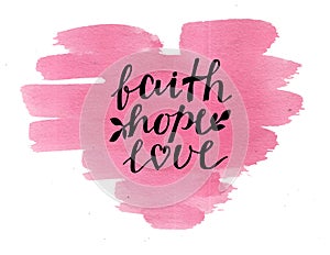 Hand lettering Faith, hope and love on watercolor heart.