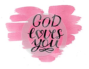 Hand lettering God loves you on watercolor pink heart