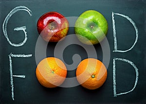 Hand Lettering Good Food on Black Chalkboard with Fruits Oranges Green Red Apples. Healthy Clean Eating Vegan. Vitamins Energy.