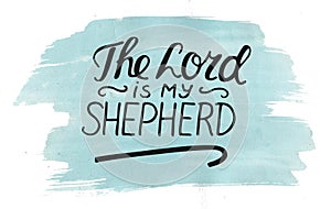 Hand lettering The Lord is my shepherd with stick on watercolor background.