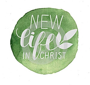 Hand lettering New life in Christ made on green watercolor background