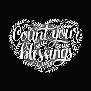 Hand lettering with quotes Count your blessing with leaves in shape of heart on black background.