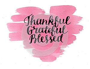 Hand lettering Thankful, grateful, blessed on watercolor heart. photo