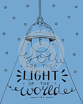 Hand lettering You the light of the world, made on the star background with glowing light bulb