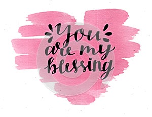 Hand lettering You are my blessing, made on watercolor pink heart.