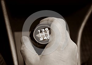 Hand on a lever of switching of transmissions an auto