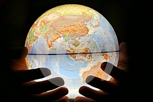 Hand on light globe