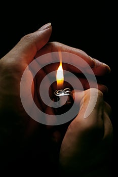 Hand with lighter, vertical