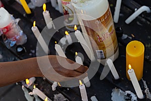 A hand lighting a candle